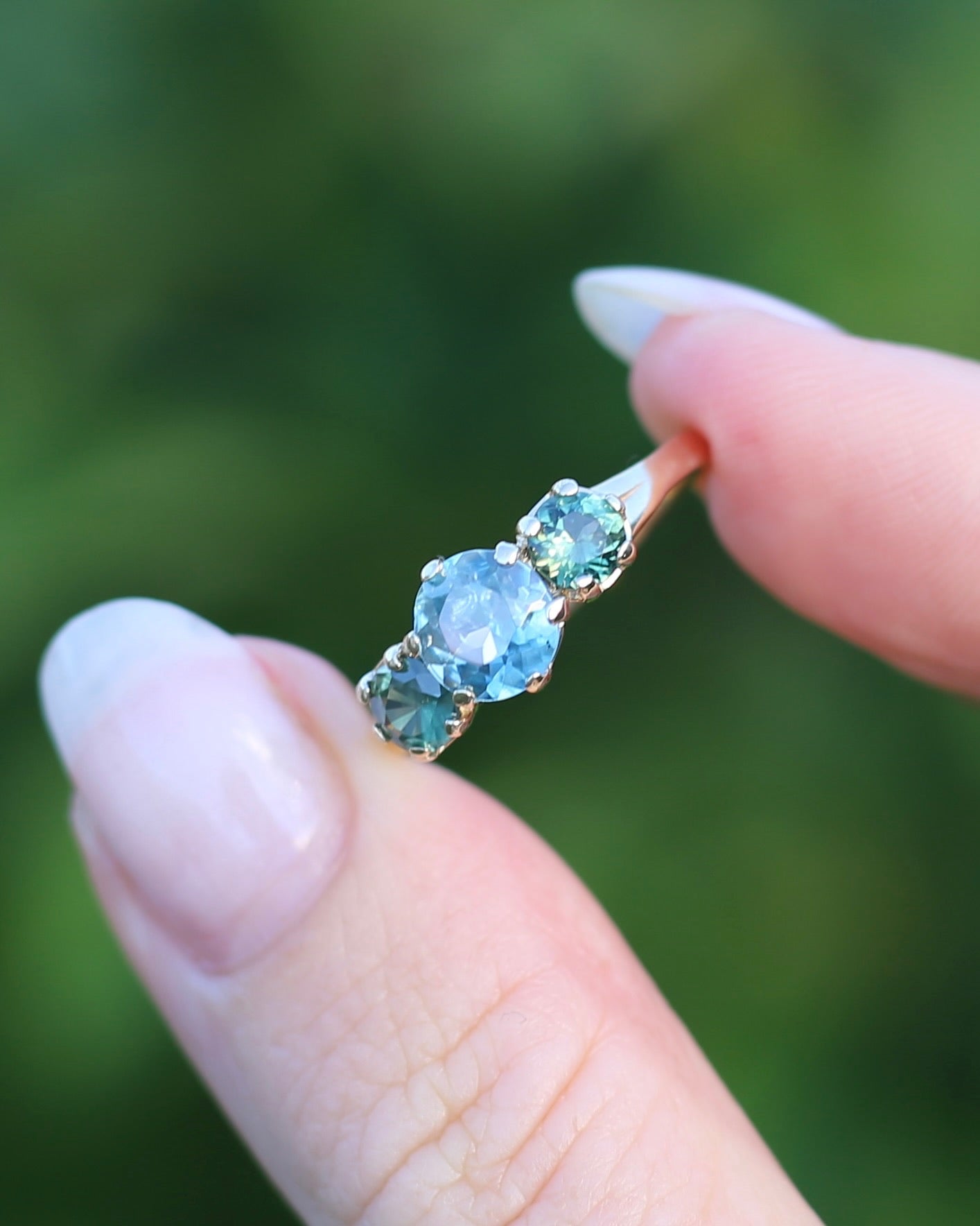 1.65ct Blue Zircon and 097ct Parti Sapphire Trilogy, 9ct Yellow Gold, size R1/2 or 8.75