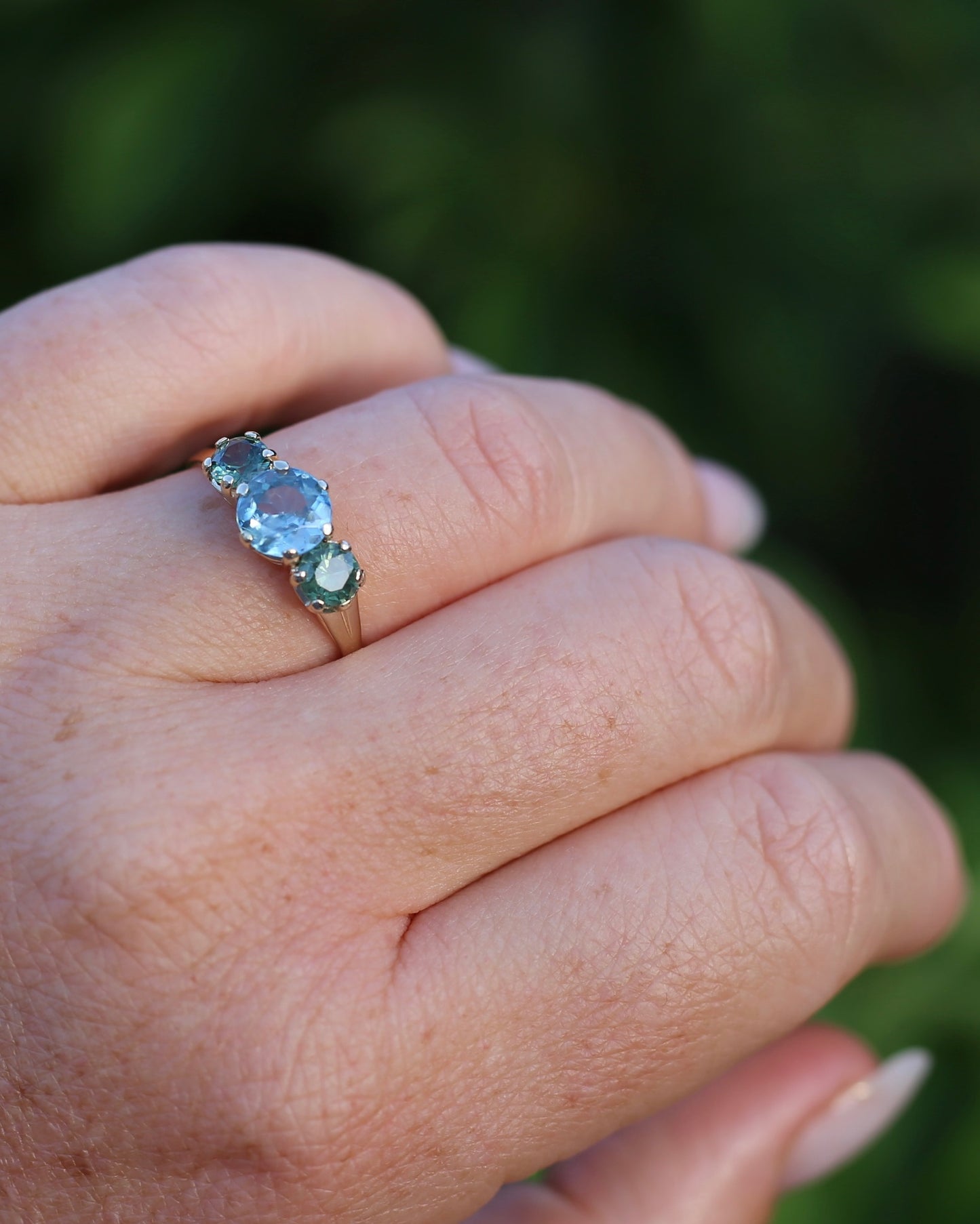 1.65ct Blue Zircon and 097ct Parti Sapphire Trilogy, 9ct Yellow Gold, size R1/2 or 8.75