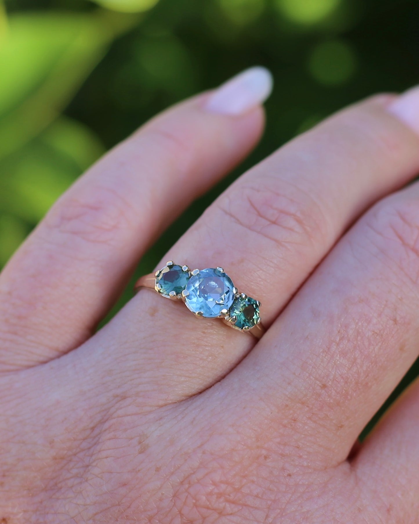 1.65ct Blue Zircon and 097ct Parti Sapphire Trilogy, 9ct Yellow Gold, size R1/2 or 8.75