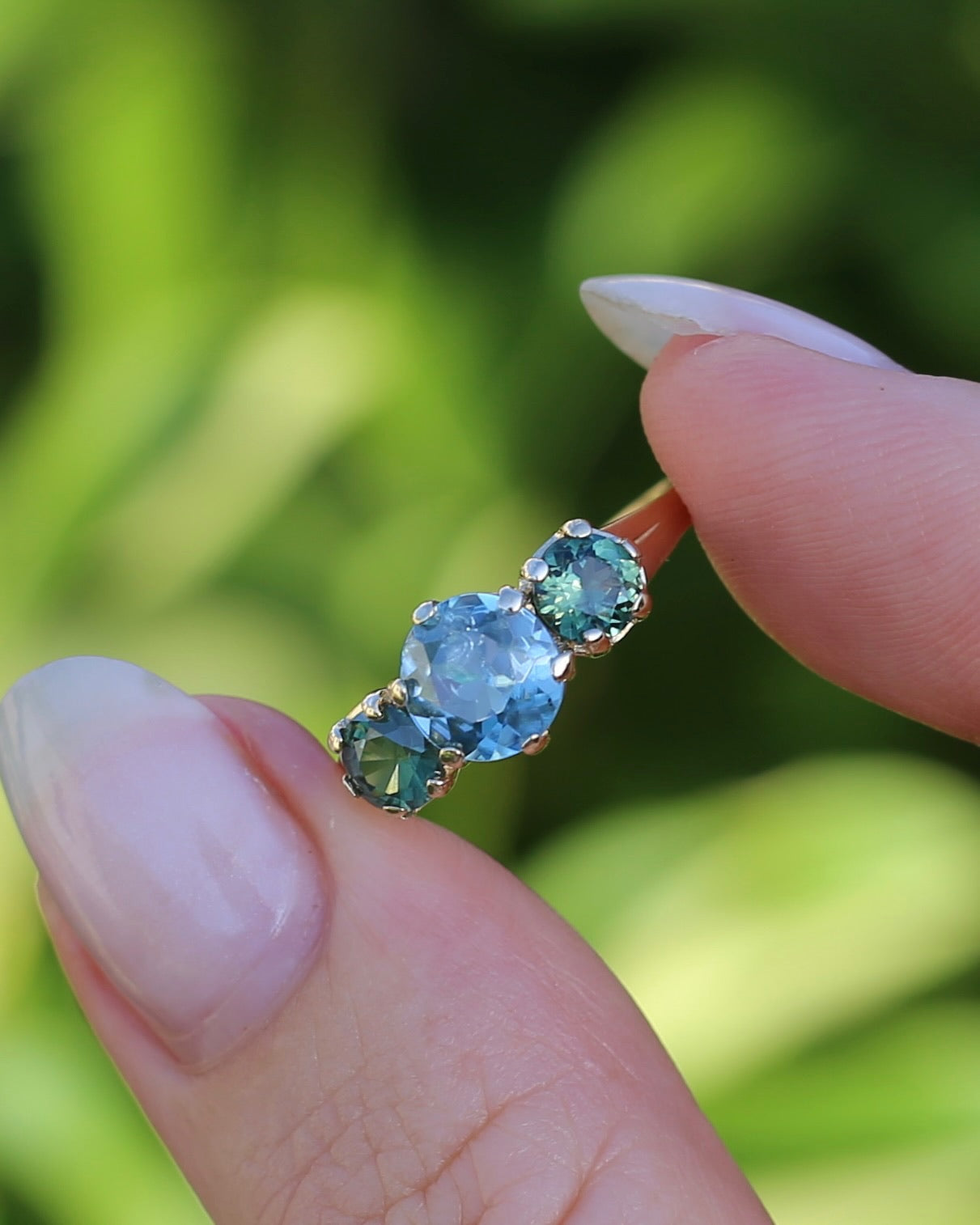 1.65ct Blue Zircon and 097ct Parti Sapphire Trilogy, 9ct Yellow Gold, size R1/2 or 8.75