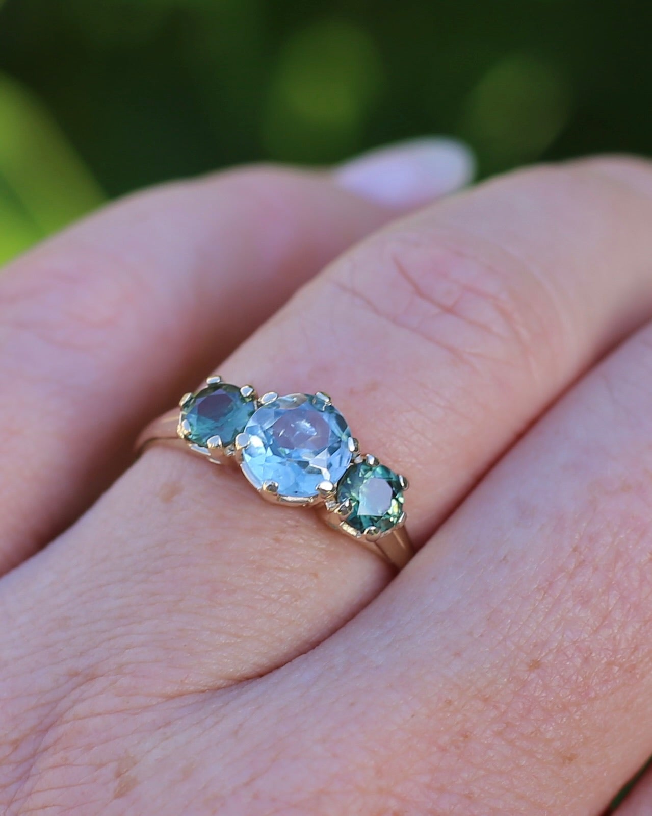 1.65ct Blue Zircon and 097ct Parti Sapphire Trilogy, 9ct Yellow Gold, size R1/2 or 8.75