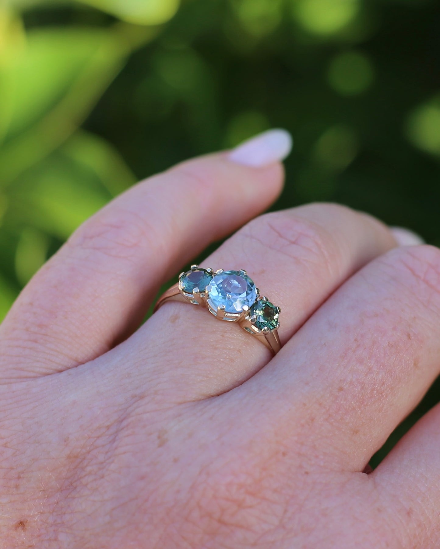 1.65ct Blue Zircon and 097ct Parti Sapphire Trilogy, 9ct Yellow Gold, size R1/2 or 8.75