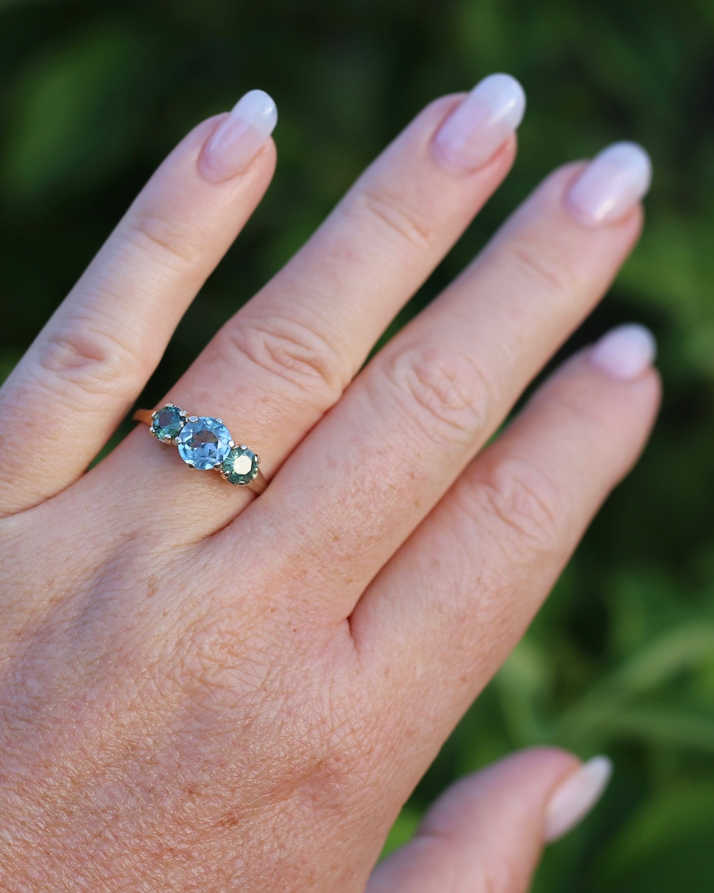 1.65ct Blue Zircon and 097ct Parti Sapphire Trilogy, 9ct Yellow Gold, size R1/2 or 8.75