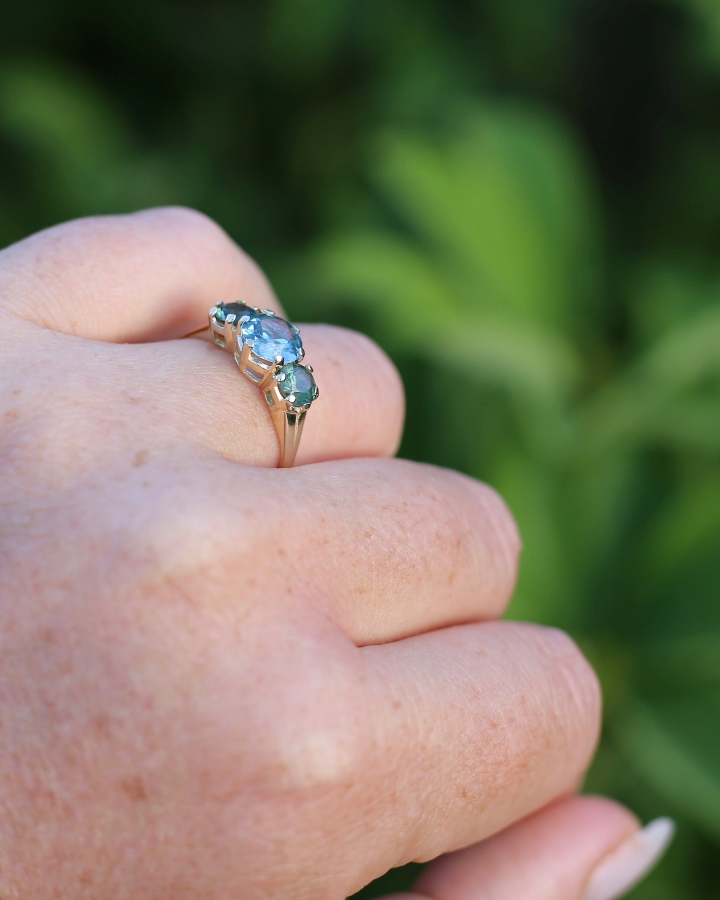 1.65ct Blue Zircon and 097ct Parti Sapphire Trilogy, 9ct Yellow Gold, size R1/2 or 8.75