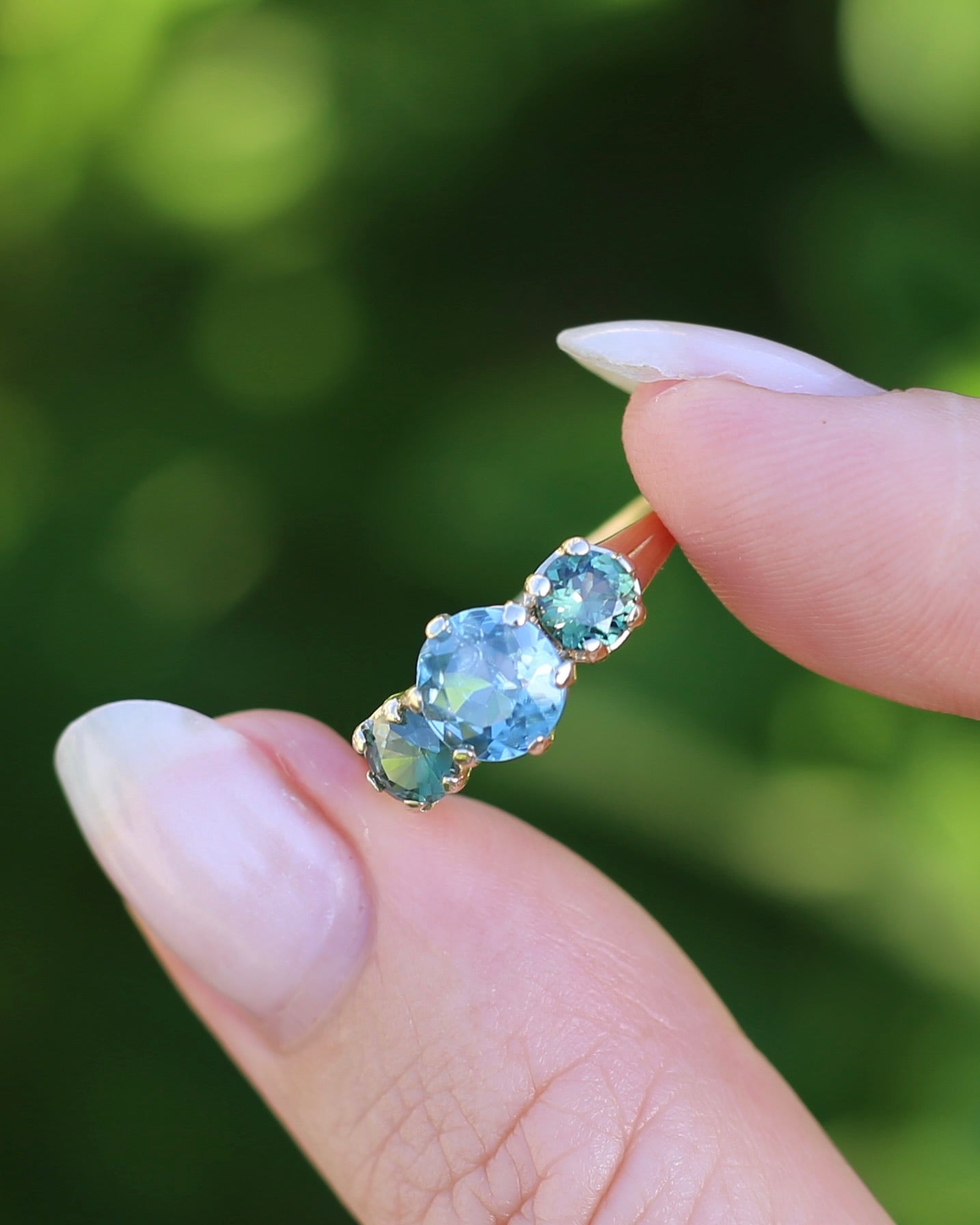 1.65ct Blue Zircon and 097ct Parti Sapphire Trilogy, 9ct Yellow Gold, size R1/2 or 8.75