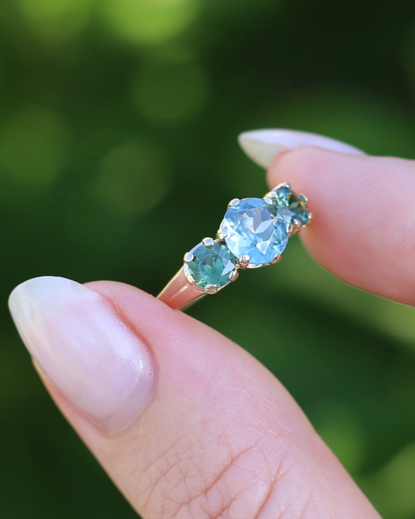 1.65ct Blue Zircon and 097ct Parti Sapphire Trilogy, 9ct Yellow Gold, size R1/2 or 8.75