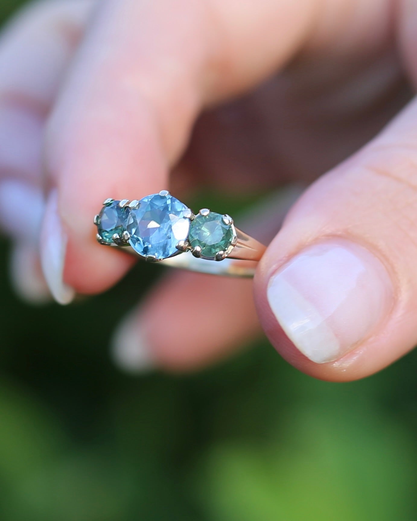 1.65ct Blue Zircon and 097ct Parti Sapphire Trilogy, 9ct Yellow Gold, size R1/2 or 8.75