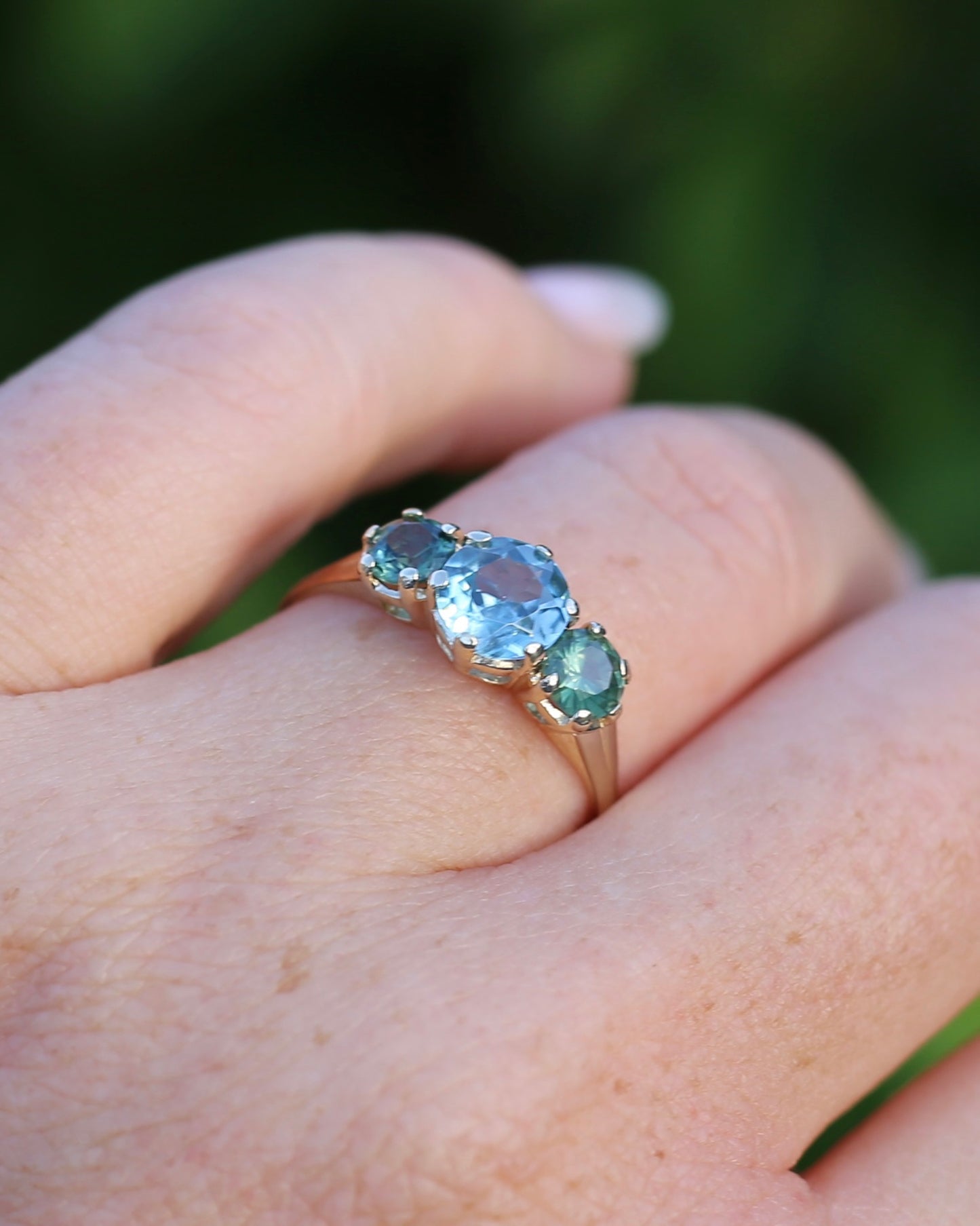 1.65ct Blue Zircon and 097ct Parti Sapphire Trilogy, 9ct Yellow Gold, size R1/2 or 8.75