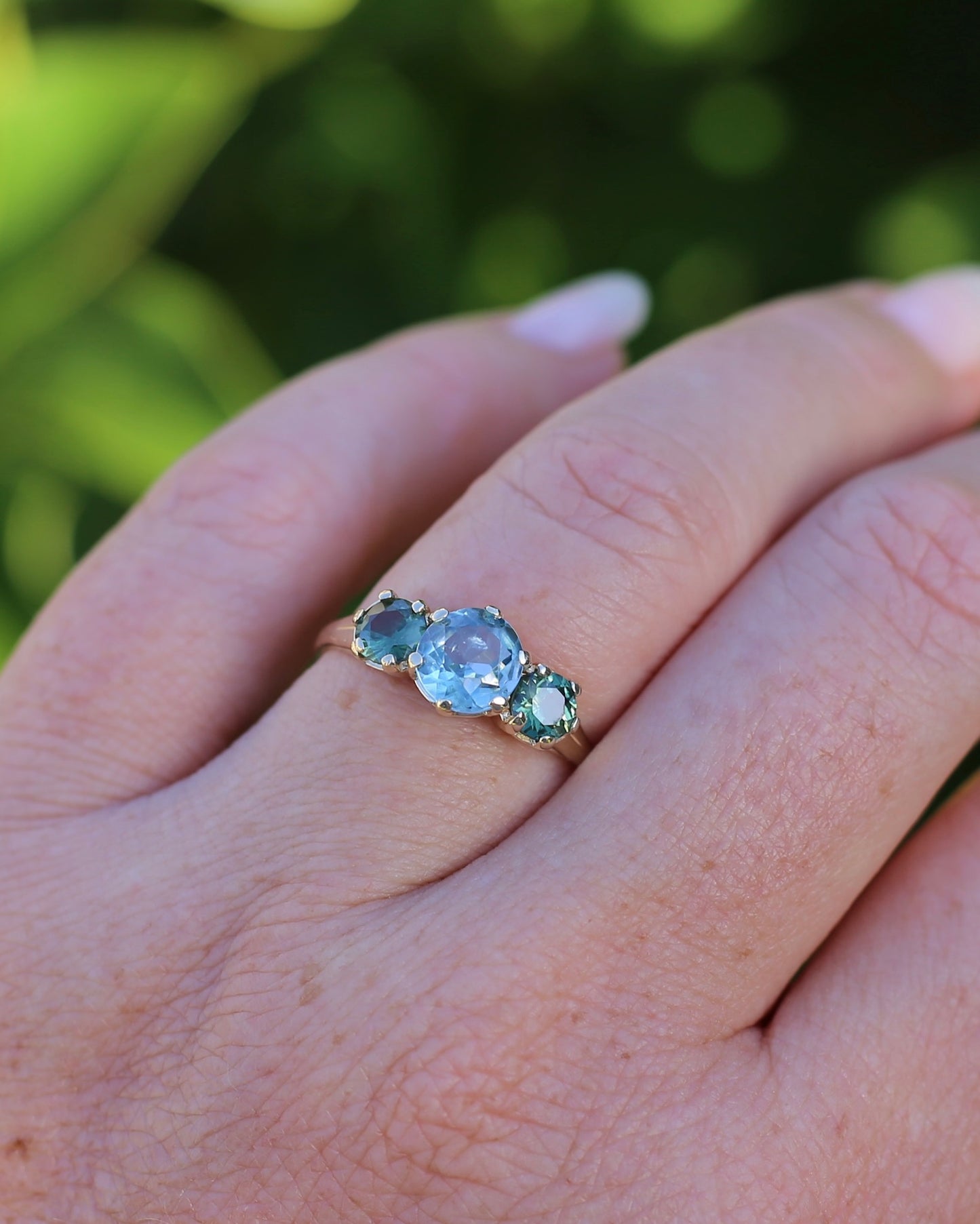 1.65ct Blue Zircon and 097ct Parti Sapphire Trilogy, 9ct Yellow Gold, size R1/2 or 8.75