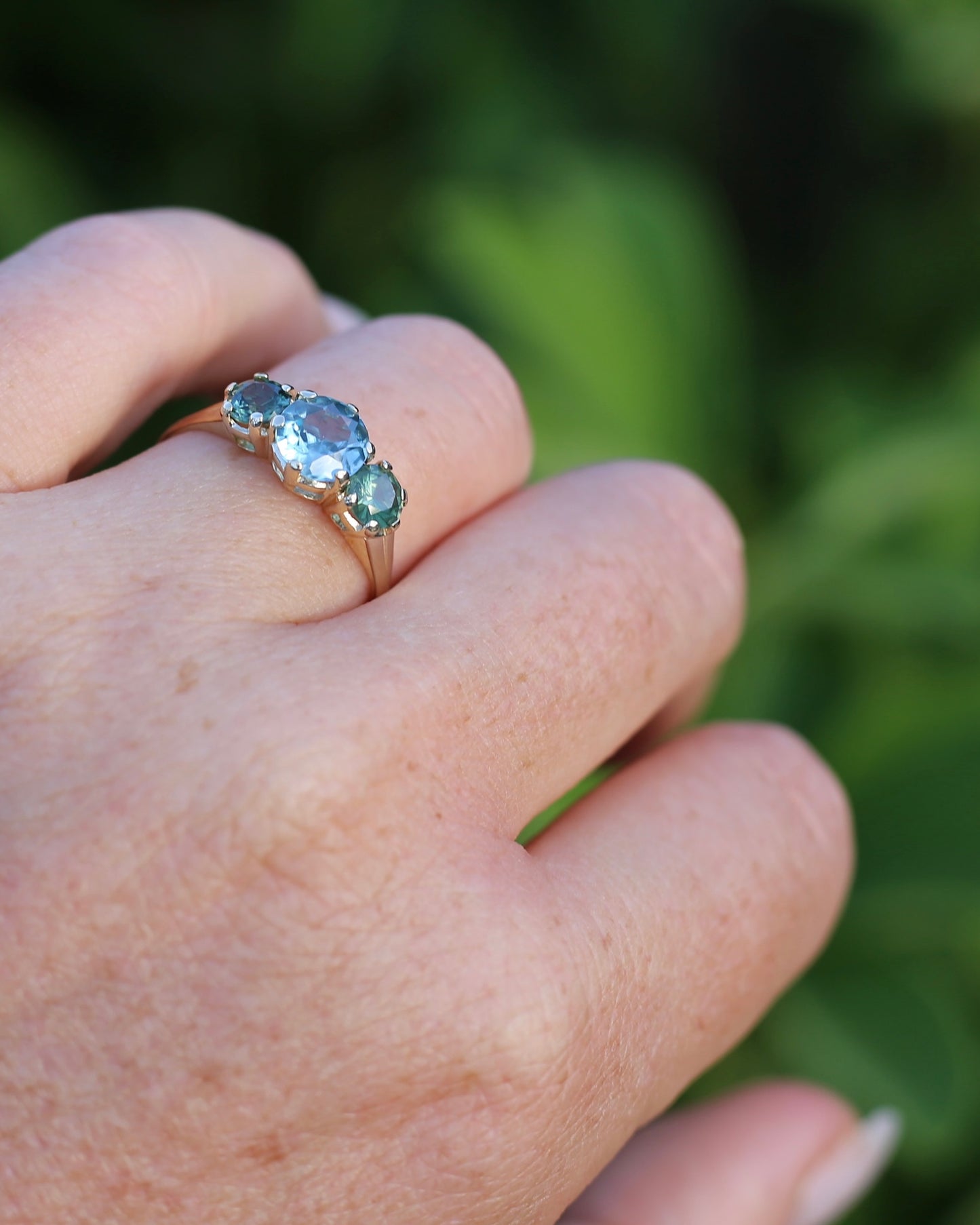 1.65ct Blue Zircon and 097ct Parti Sapphire Trilogy, 9ct Yellow Gold, size R1/2 or 8.75