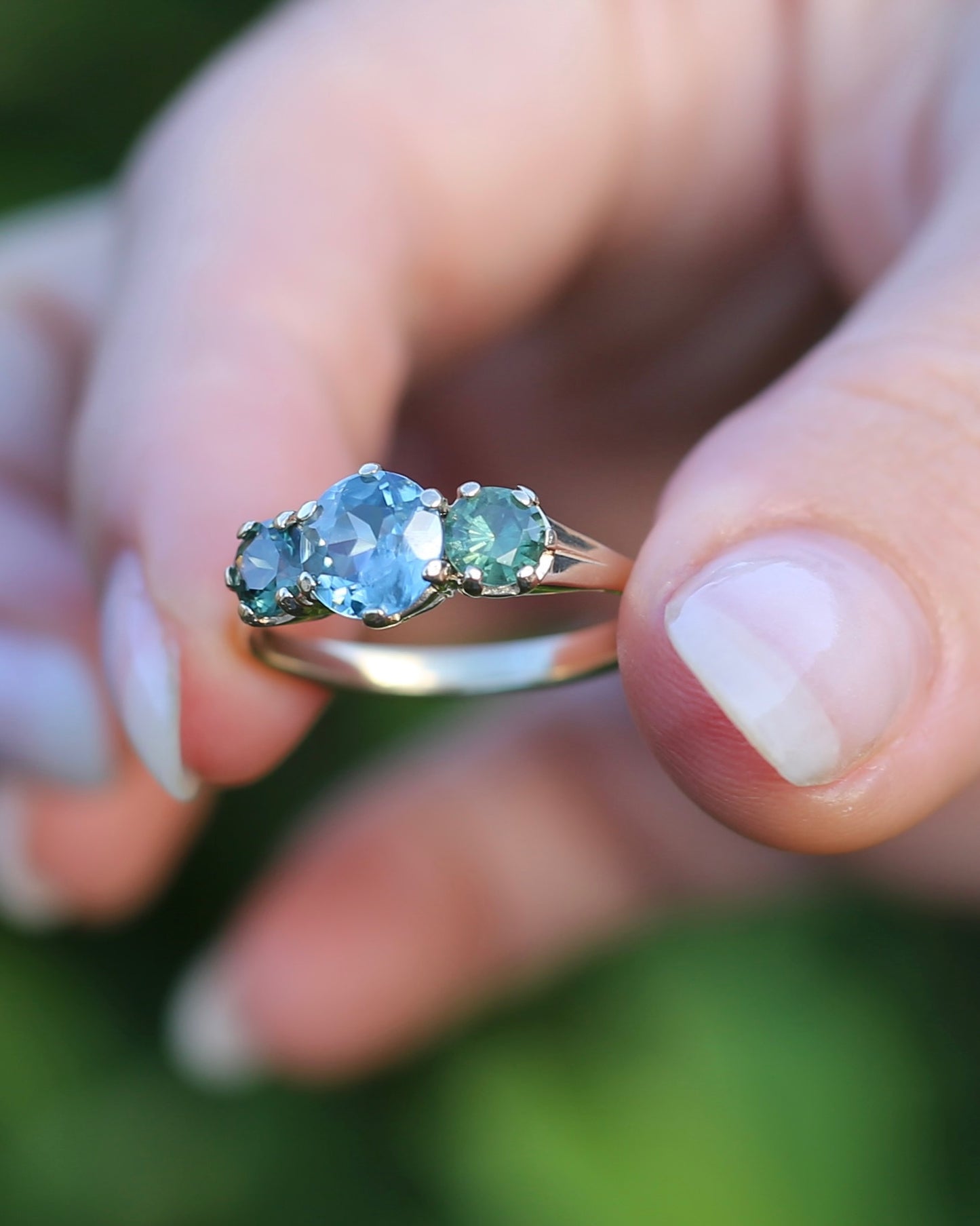 1.65ct Blue Zircon and 097ct Parti Sapphire Trilogy, 9ct Yellow Gold, size R1/2 or 8.75