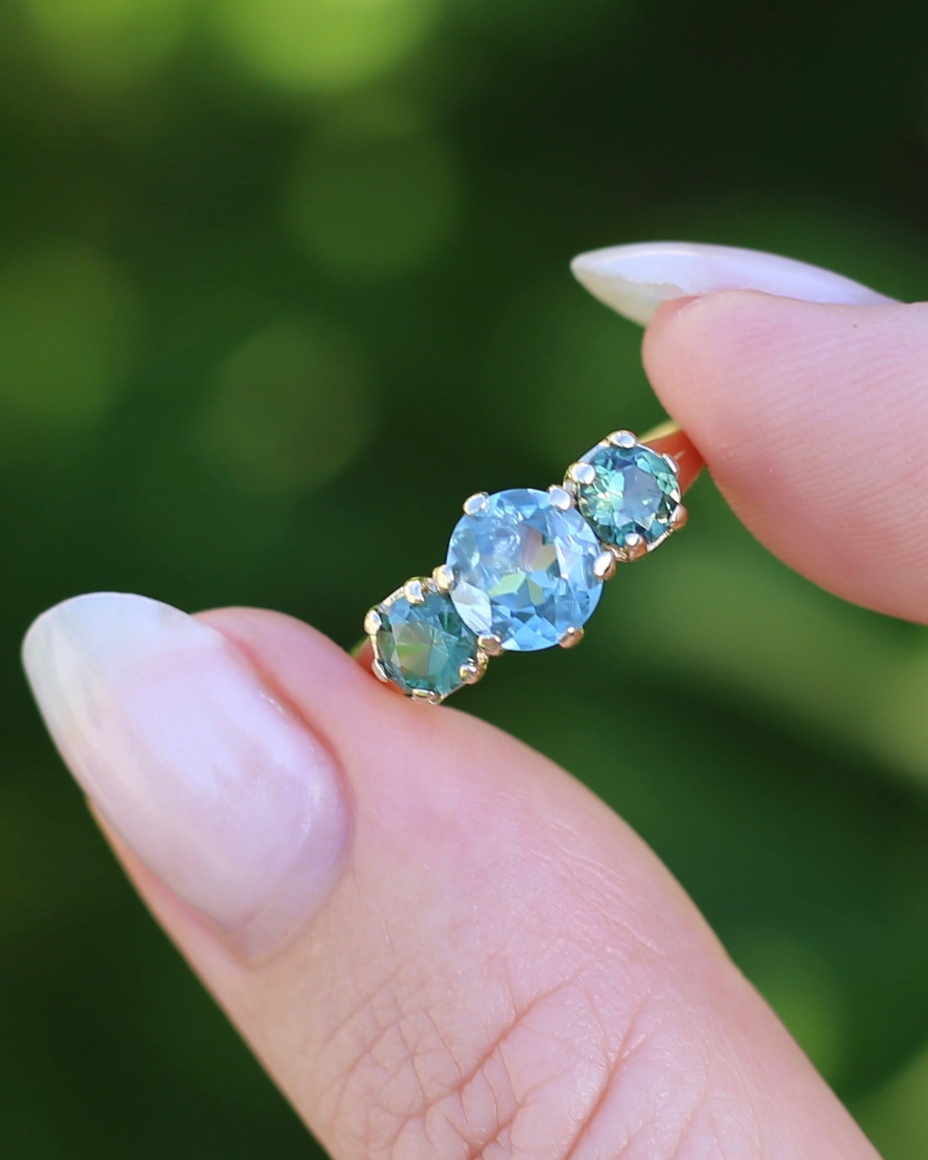 1.65ct Blue Zircon and 097ct Parti Sapphire Trilogy, 9ct Yellow Gold, size R1/2 or 8.75