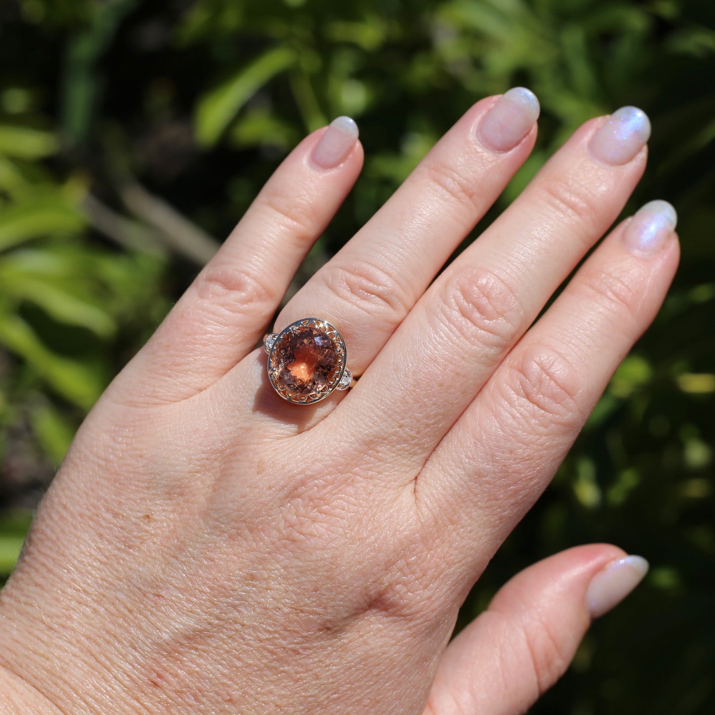 Oval Pale Orange Tourmaline Ring with Pierced Wire Surrounds and Diamonds in the Shoulders, 9ct Yellow Gold, size N or 6.75