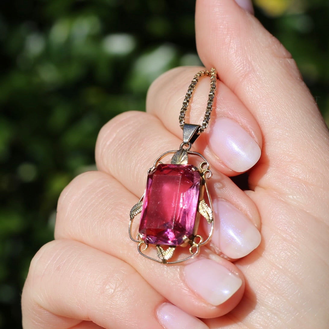 Circa 1930s-1950s Pink Paste Pendant in Decorative 9ct Gold Leaf Surround, 4.95g