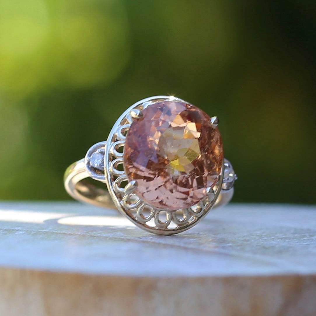 Oval Pale Orange Tourmaline Ring with Pierced Wire Surrounds and Diamonds in the Shoulders, 9ct Yellow Gold, size N or 6.75