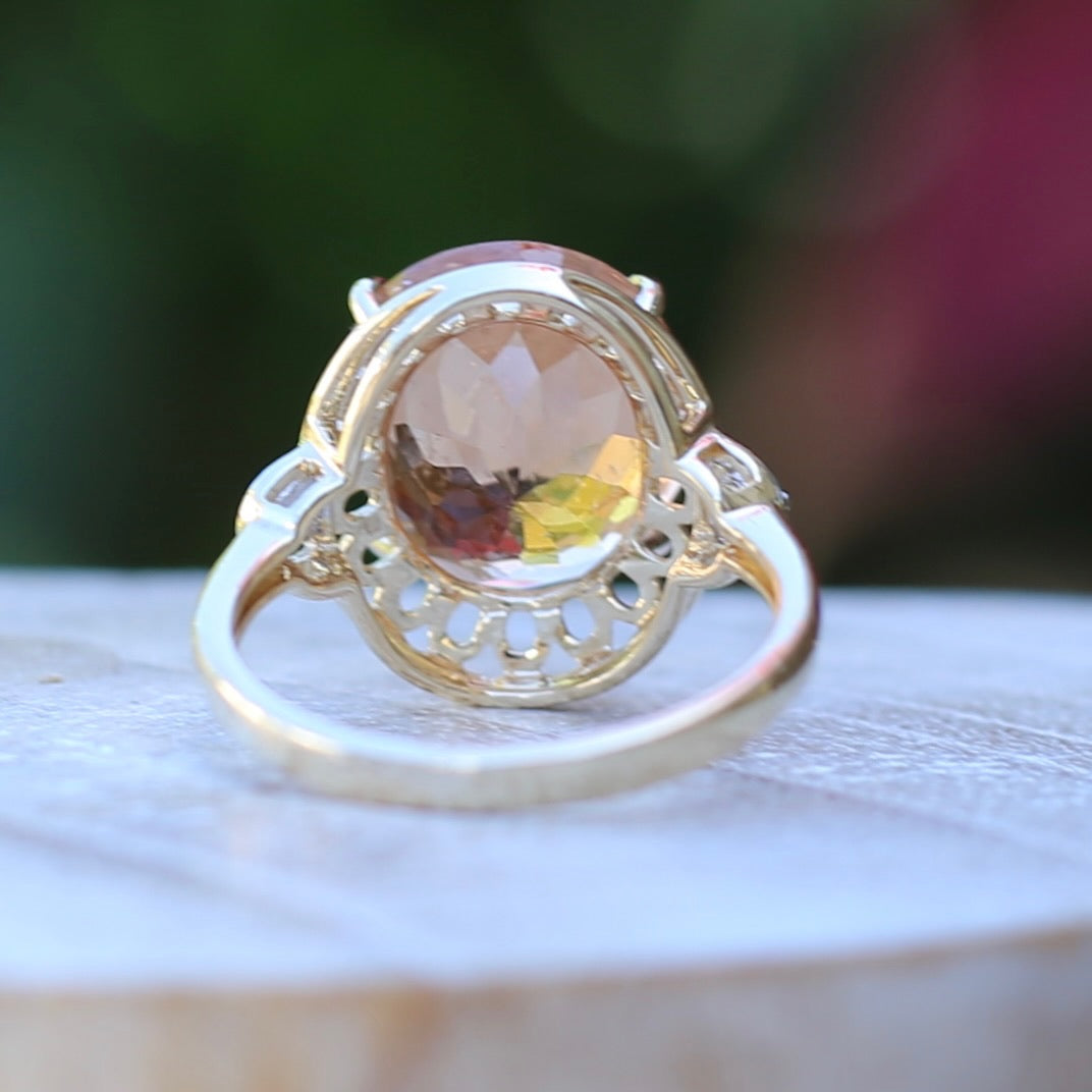 Oval Pale Orange Tourmaline Ring with Pierced Wire Surrounds and Diamonds in the Shoulders, 9ct Yellow Gold, size N or 6.75