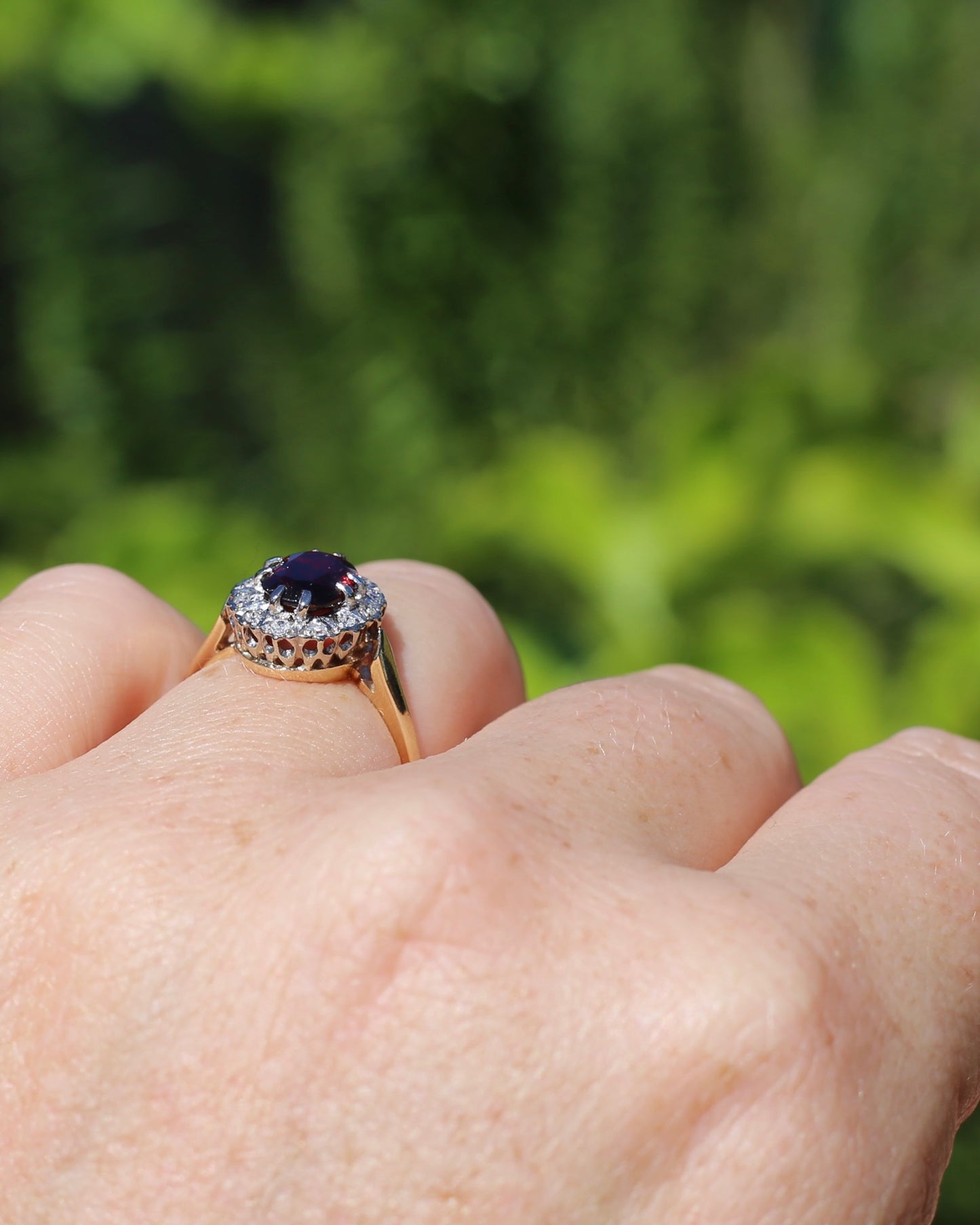 1974 Made Garnet and Diamond Halo Ring, 9ct Yellow and White Gold, size M1/2 or 6.5, 2.83g