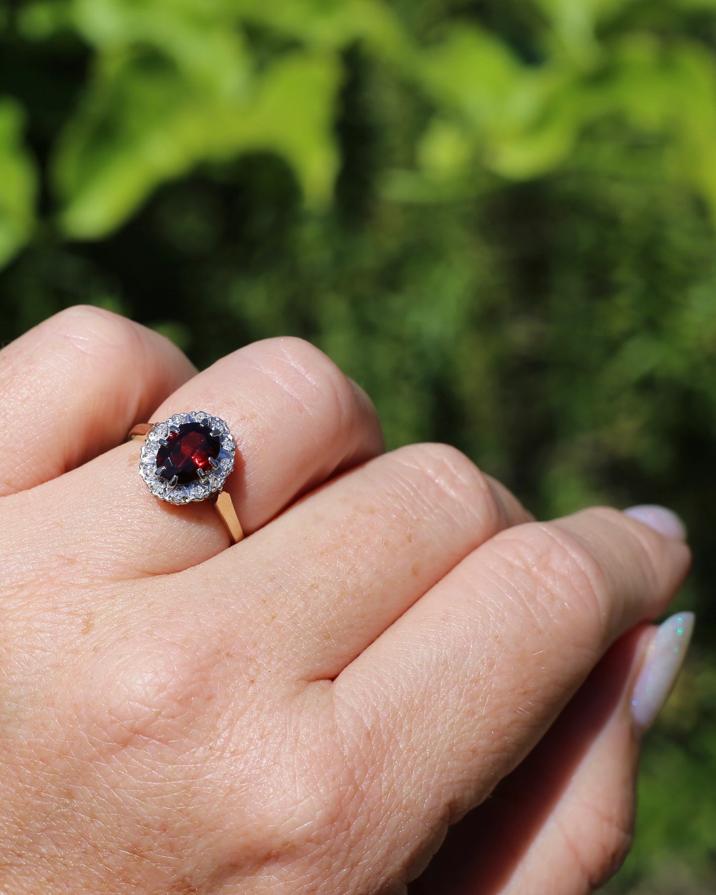 1974 Made Garnet and Diamond Halo Ring, 9ct Yellow and White Gold, size M1/2 or 6.5, 2.83g