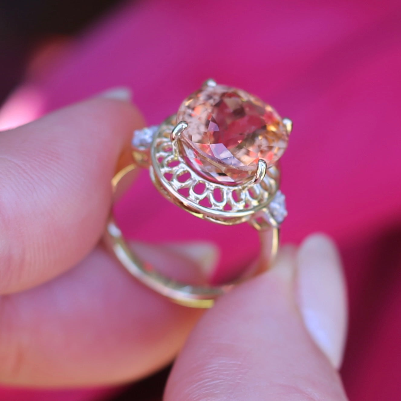 Oval Pale Orange Tourmaline Ring with Pierced Wire Surrounds and Diamonds in the Shoulders, 9ct Yellow Gold, size N or 6.75