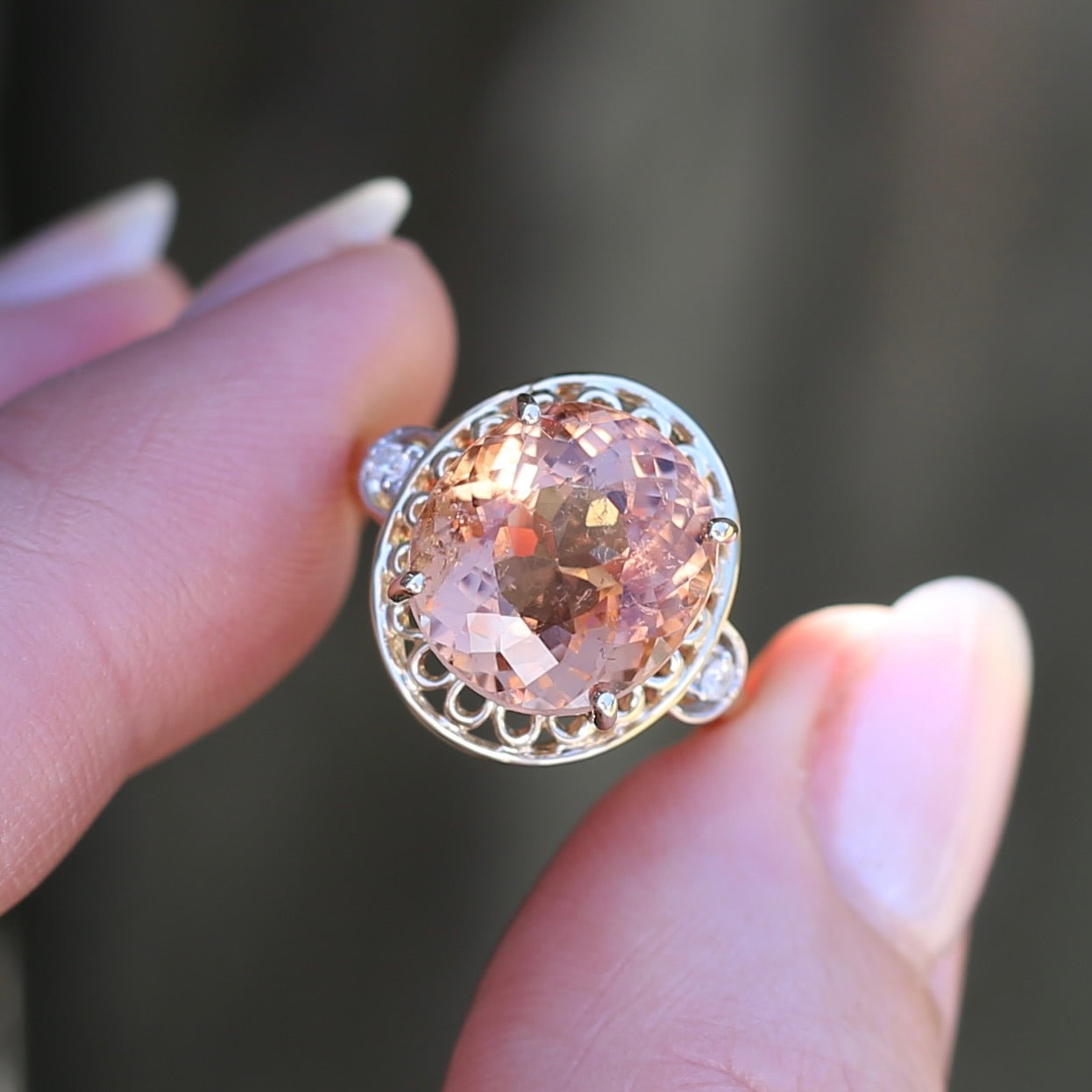 Oval Pale Orange Tourmaline Ring with Pierced Wire Surrounds and Diamonds in the Shoulders, 9ct Yellow Gold, size N or 6.75