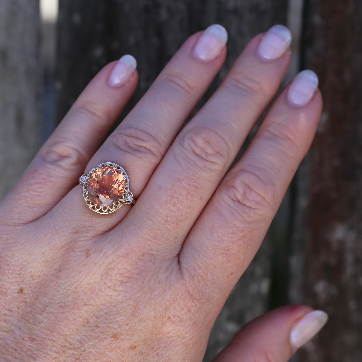 Oval Pale Orange Tourmaline Ring with Pierced Wire Surrounds and Diamonds in the Shoulders, 9ct Yellow Gold, size N or 6.75