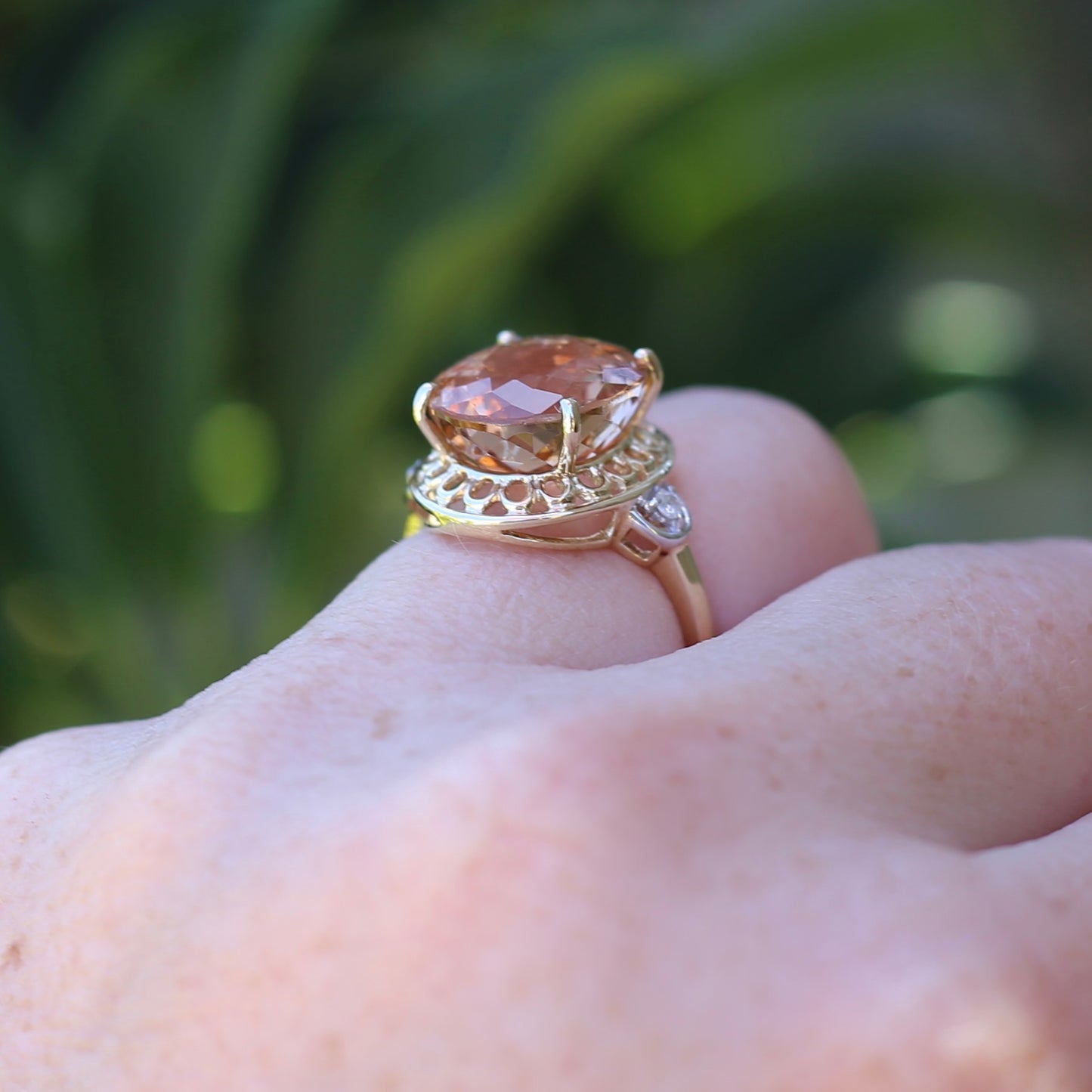 Oval Pale Orange Tourmaline Ring with Pierced Wire Surrounds and Diamonds in the Shoulders, 9ct Yellow Gold, size N or 6.75