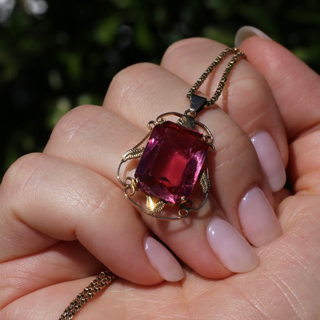 Circa 1930s-1950s Pink Paste Pendant in Decorative 9ct Gold Leaf Surround, 4.95g