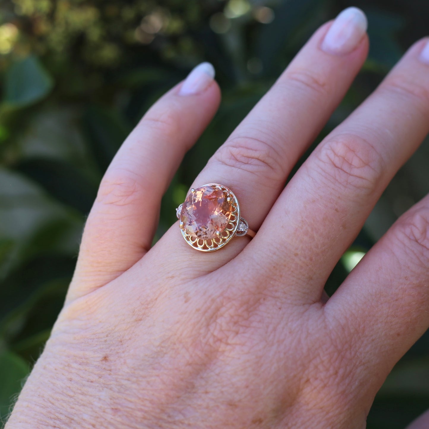 Oval Pale Orange Tourmaline Ring with Pierced Wire Surrounds and Diamonds in the Shoulders, 9ct Yellow Gold, size N or 6.75