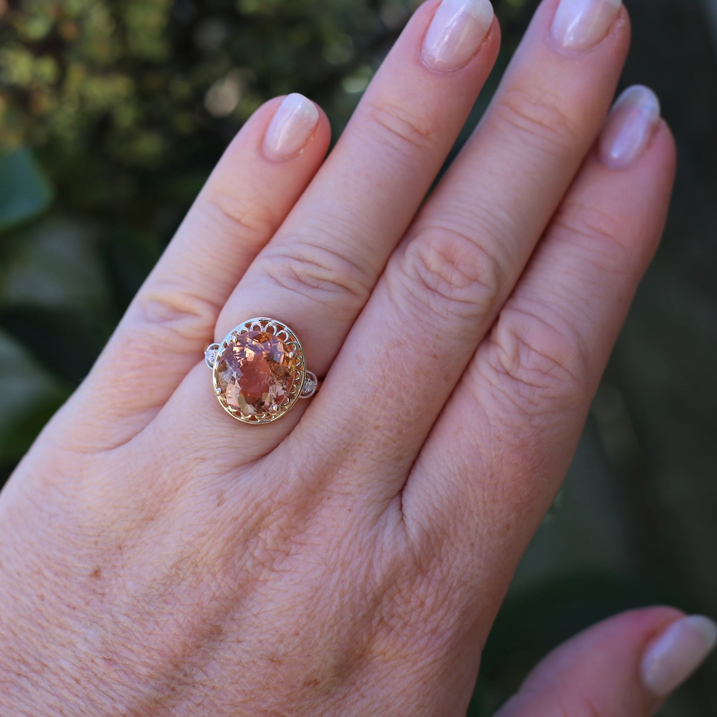 Oval Pale Orange Tourmaline Ring with Pierced Wire Surrounds and Diamonds in the Shoulders, 9ct Yellow Gold, size N or 6.75