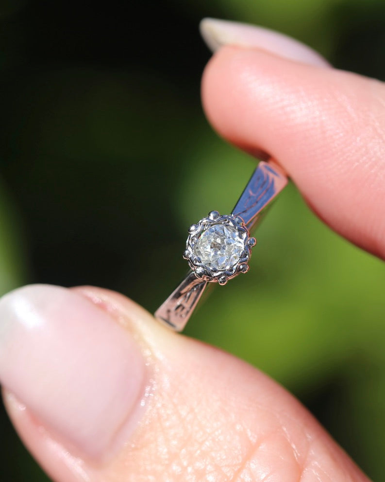 0.22ct old cut diamond solitaire, Platinum and Pale 18ct Gold, size P1/2