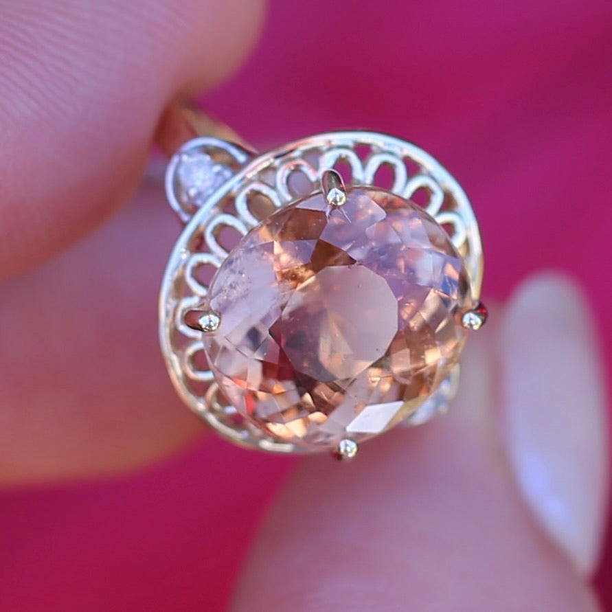 Oval Pale Orange Tourmaline Ring with Pierced Wire Surrounds and Diamonds in the Shoulders, 9ct Yellow Gold, size N or 6.75