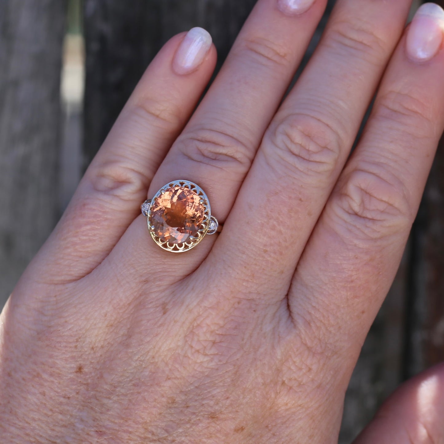 Oval Pale Orange Tourmaline Ring with Pierced Wire Surrounds and Diamonds in the Shoulders, 9ct Yellow Gold, size N or 6.75