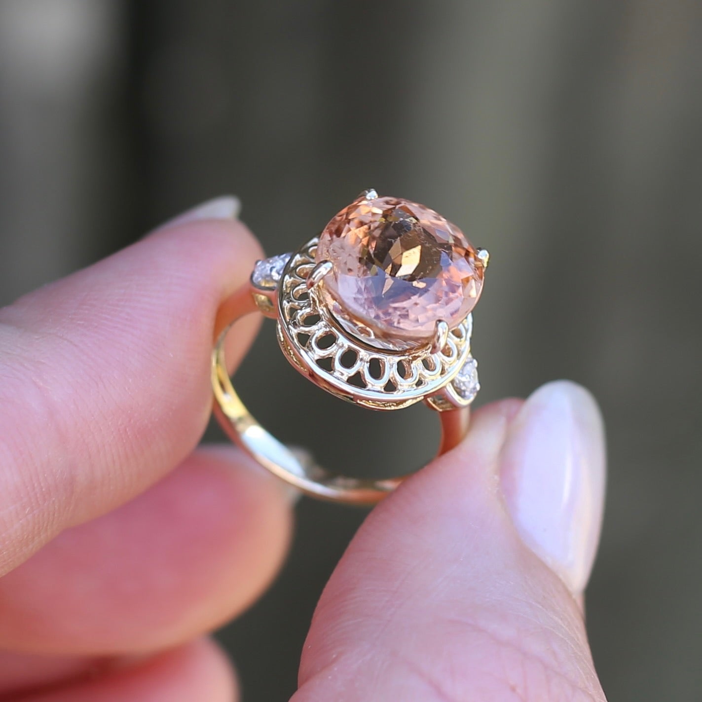 Oval Pale Orange Tourmaline Ring with Pierced Wire Surrounds and Diamonds in the Shoulders, 9ct Yellow Gold, size N or 6.75