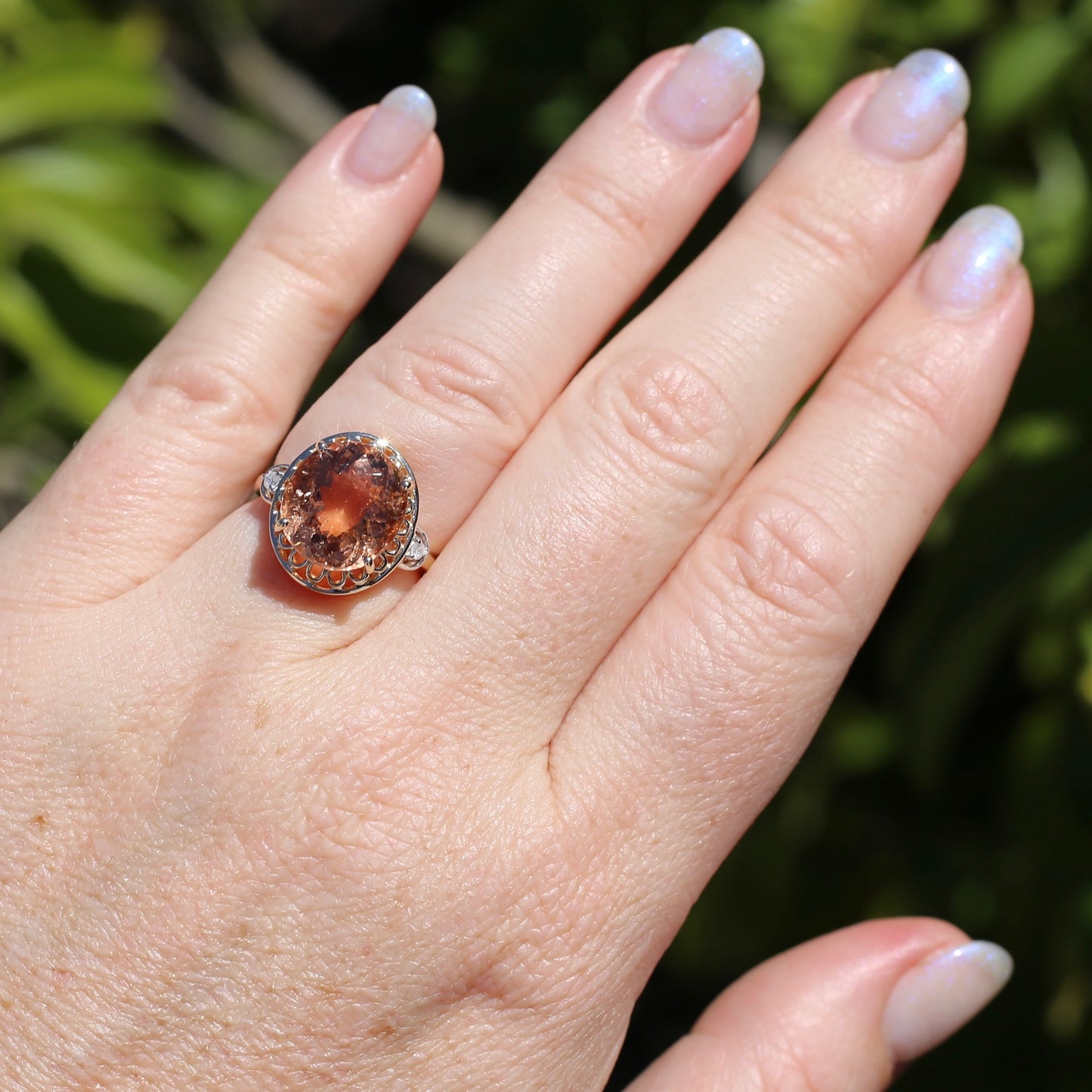 Oval Pale Orange Tourmaline Ring with Pierced Wire Surrounds and Diamonds in the Shoulders, 9ct Yellow Gold, size N or 6.75